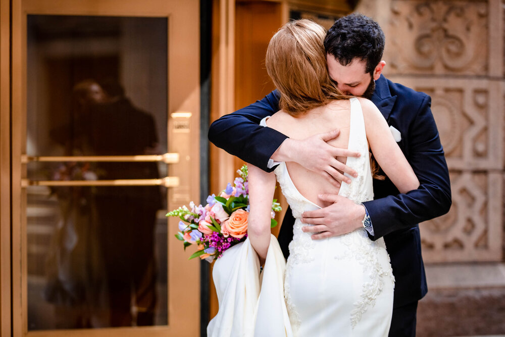 Bride and groom hug during their first look:  Chicago wedding photographs by J. Brown Photography.