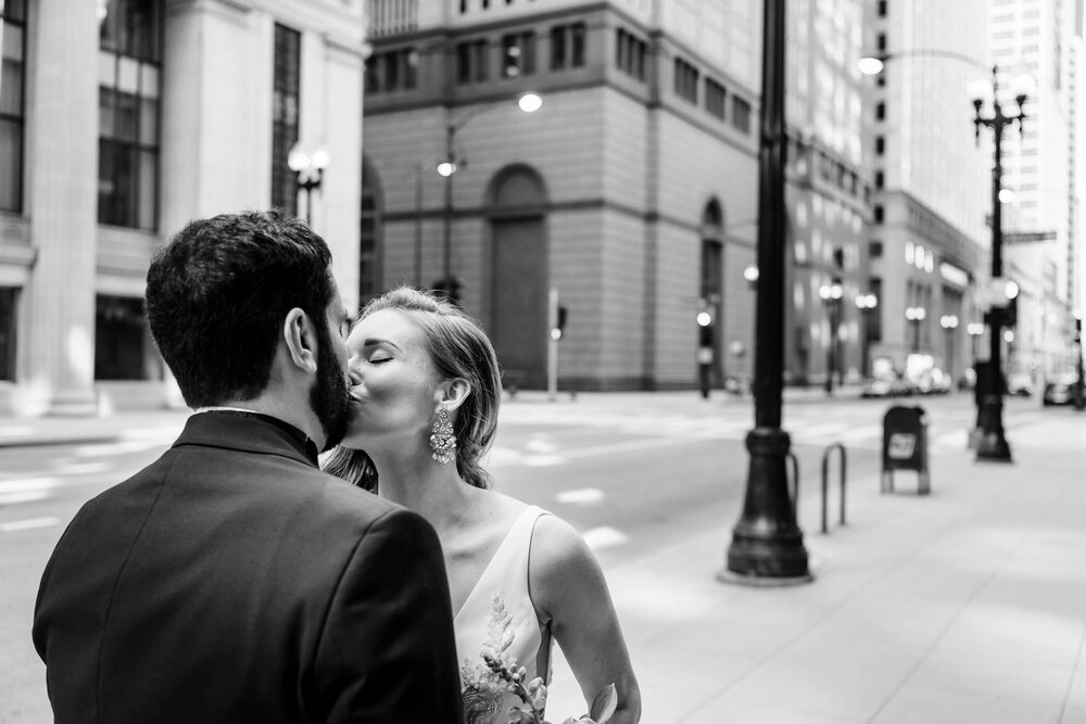 The couple kisses during the first look:  Chicago wedding photographs by J. Brown Photography.