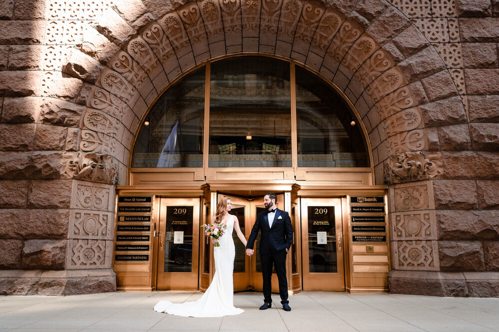 Portrait of the bride and groom outside the Rookery Building:  Chicago wedding photographs by J. Brown Photography.