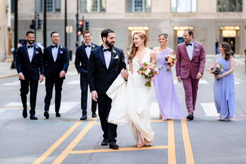 Candid portrait of the wedding party on LaSalle Street:  Chicago wedding photographs by J. Brown Photography.
