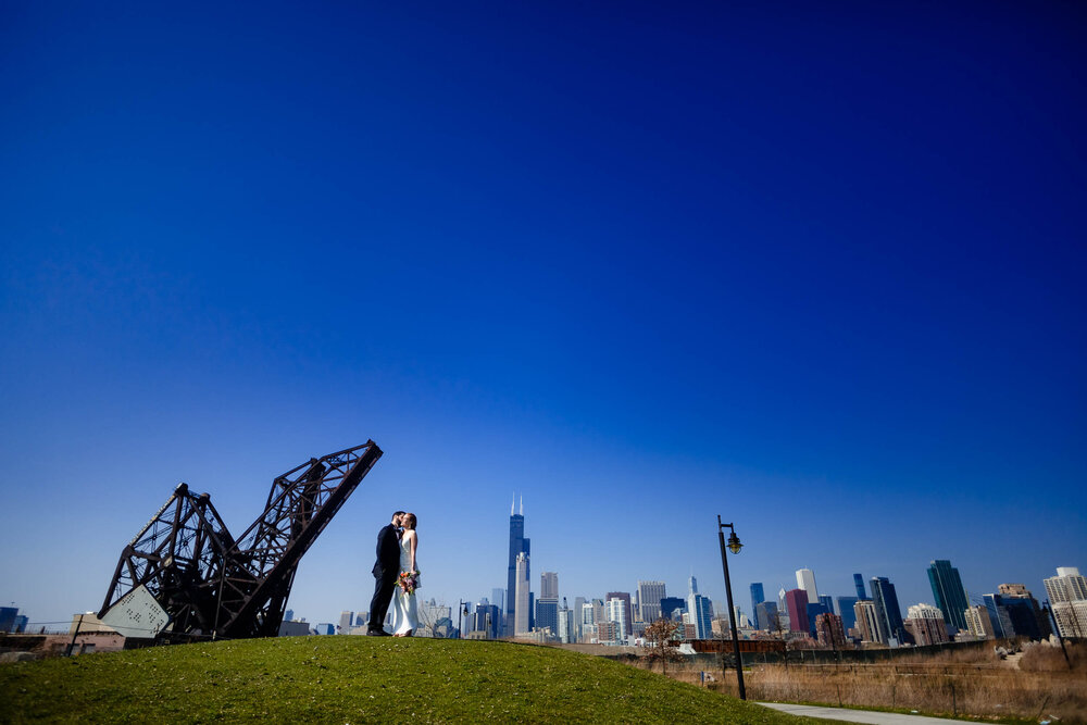 Creative photo of the couple with the skyline at Ping Tom Park:  Chicago wedding photographs by J. Brown Photography.