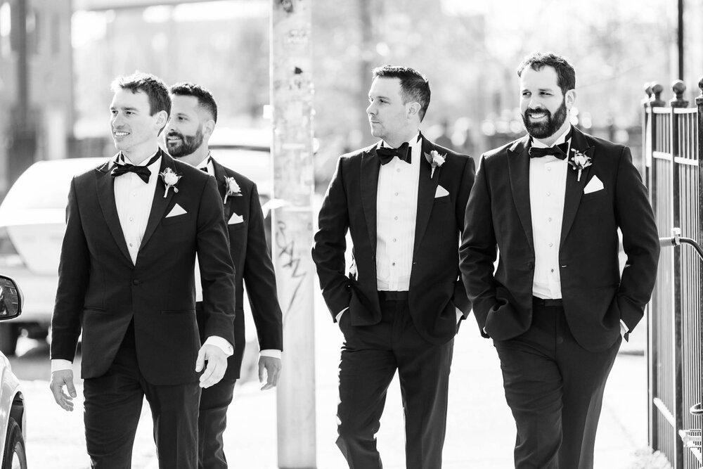 Candid moment of the groomsmen at Ping Tom Park:  Chicago wedding photographs by J. Brown Photography.