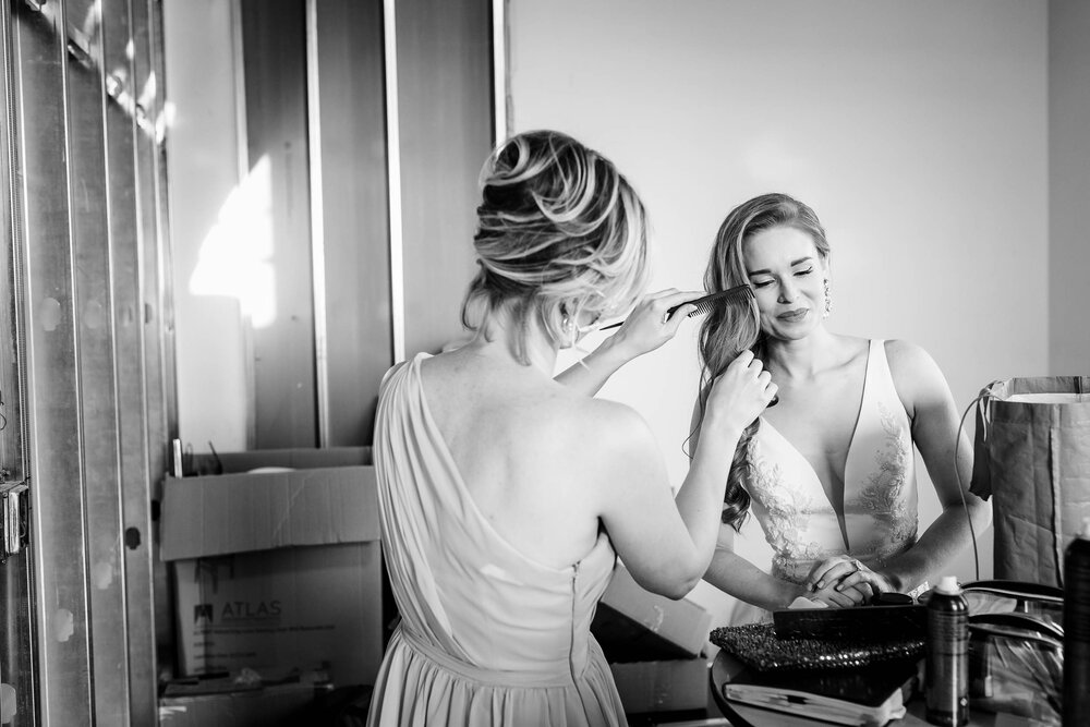 Bride getting ready with her matron of honor before the ceremony at the Stockhouse:  Chicago wedding photographs by J. Brown Photography.