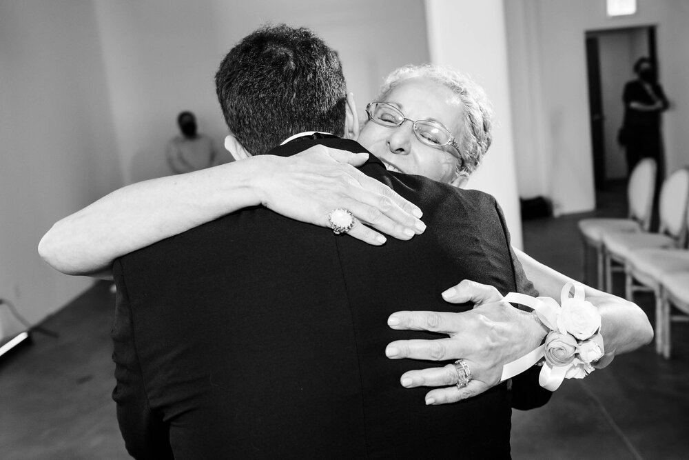 Mom hugs her son the groom during a ceremony at the Stockhouse: Chicago wedding photographs by J. Brown Photography.