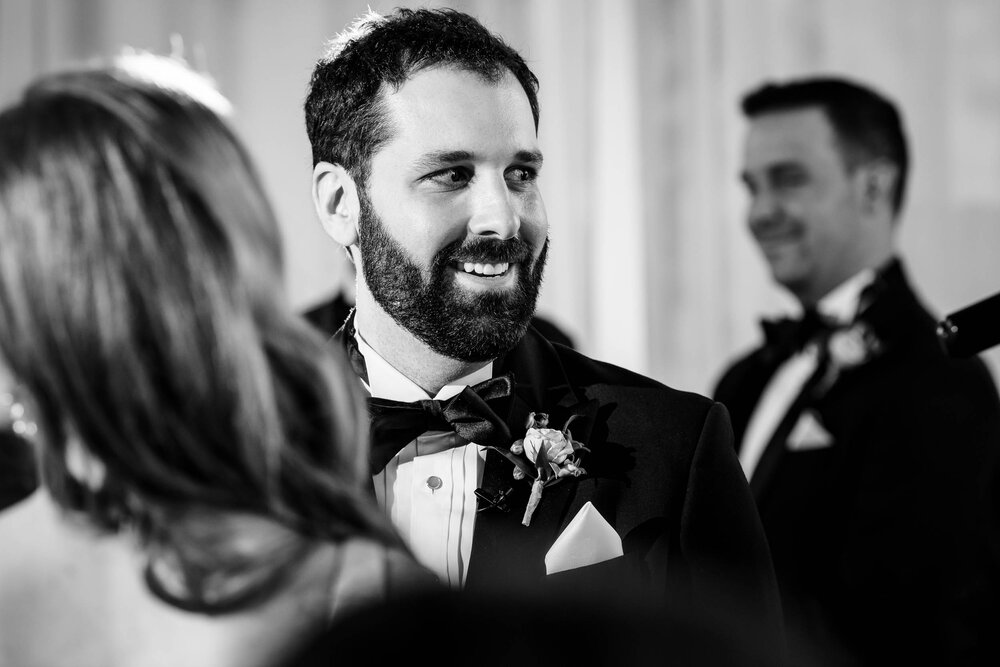 Groom smiles during the ceremony at a Stockhouse: Chicago wedding photographs by J. Brown Photography.