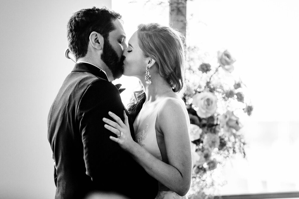 First kiss moment during a ceremony at the Stockhouse:  Chicago wedding photographs by J. Brown Photography.