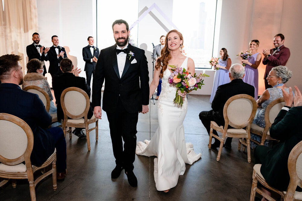 Bride and groom walk down the aisle during their ceremony at the Stockhouse:  Chicago wedding photographs by J. Brown Photography.
