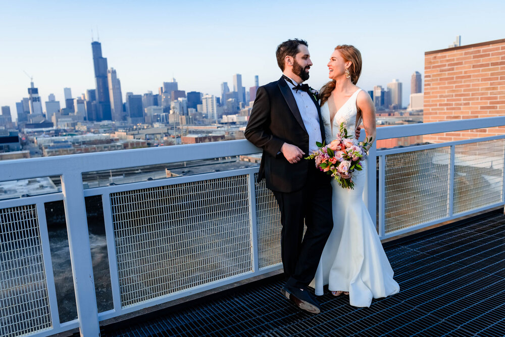 Fun portrait of the bride and groom at sunset on the roof of the Stockhouse:  Chicago wedding photographs by J. Brown Photography.