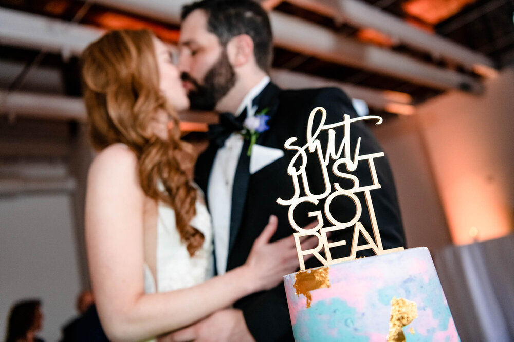 Bride and groom kiss during their cake cutting at the Stockhouse: Chicago wedding photographs by J. Brown Photography.