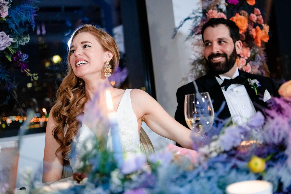 Bride and groom reacts during their wedding party toasts:  Chicago wedding photographs by J. Brown Photography.