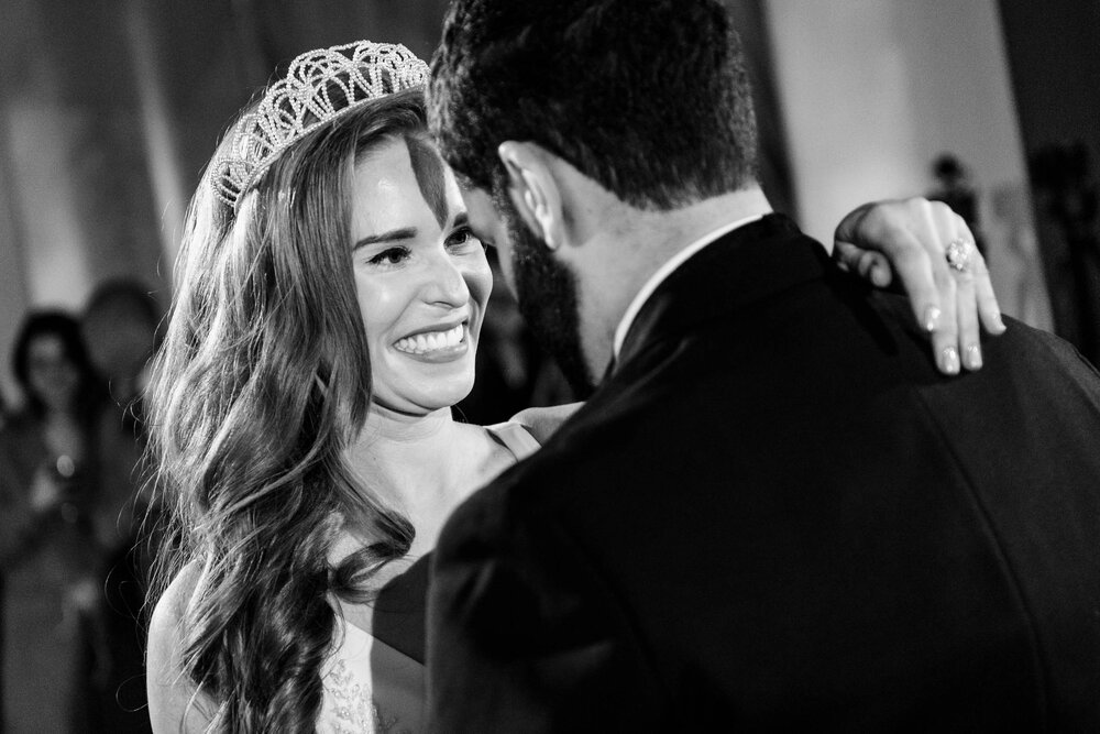 Bride smiles during the first dance at the Stockhouse:  Chicago wedding photographs by J. Brown Photography.