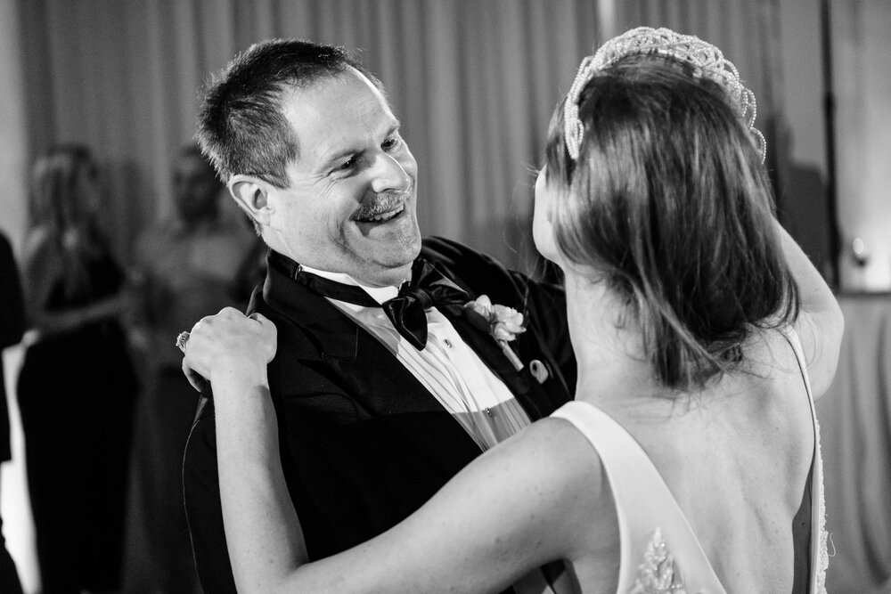 Father laughs with his daughter during a reception at the Stockhouse: Chicago wedding photographs by J. Brown Photography.