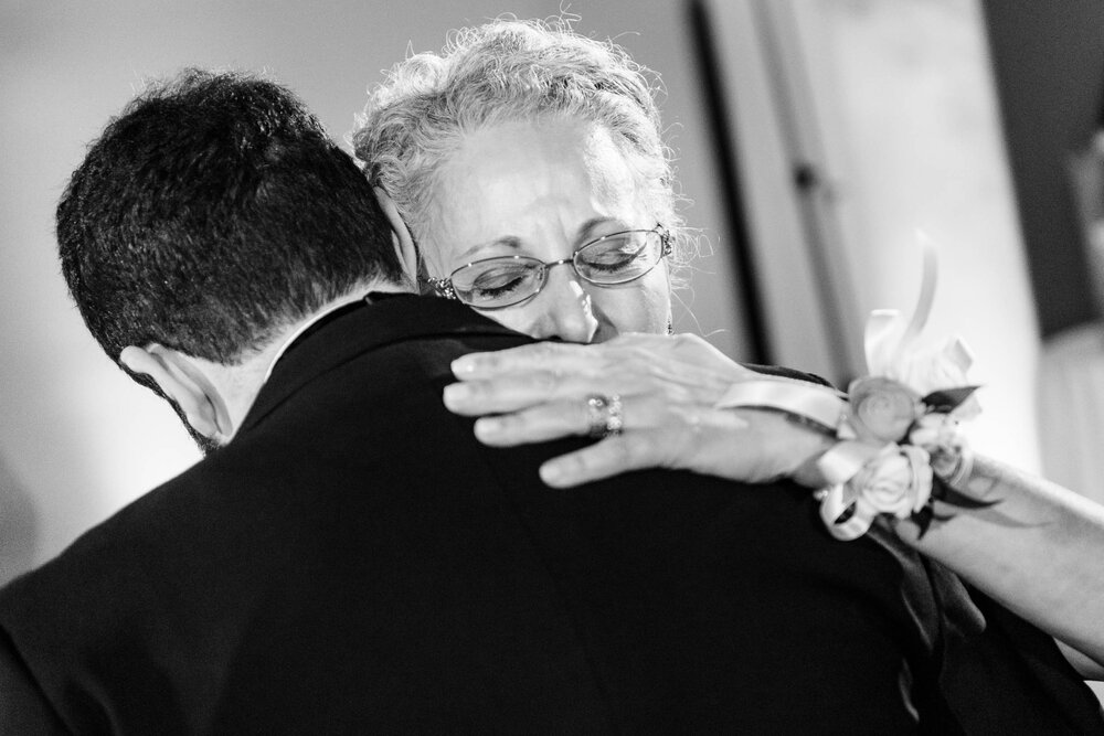 Mom hugs her son during their dance at the Stockhouse: Chicago wedding photographs by J. Brown Photography.