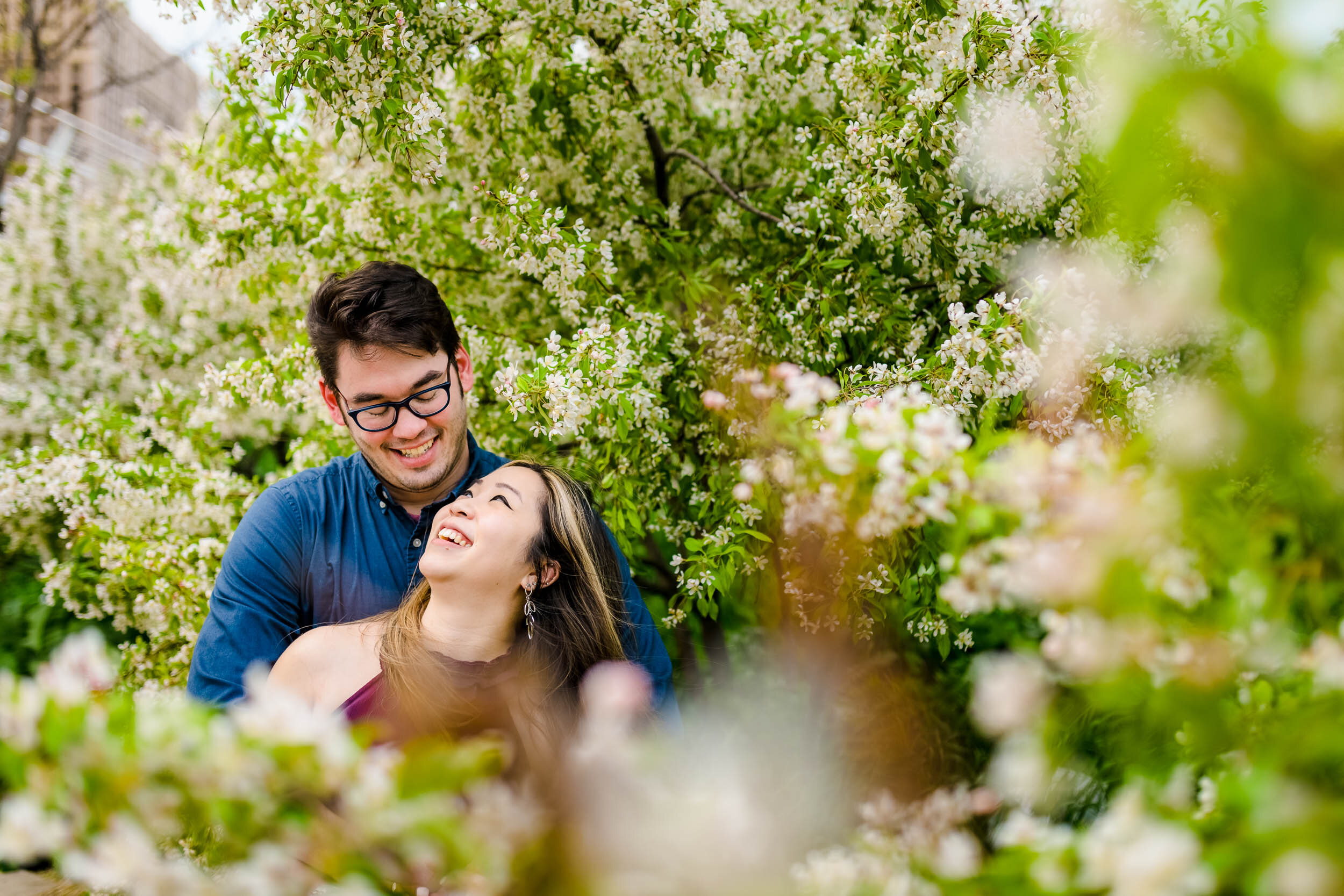 Engagement Photographer Chicago | Milton Lee Olive Park | J. Brown Photography | portrait of couple laughing with greenery.