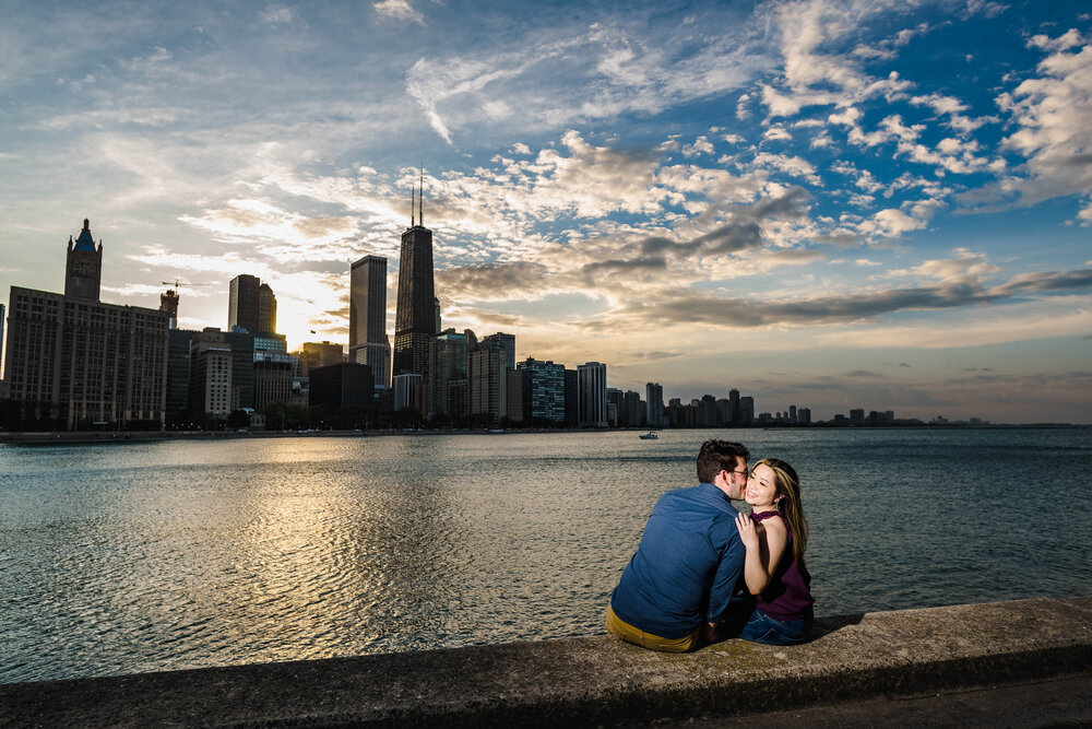 Best Engagement Photographers Near Me | Milton Lee Olive Park | J. Brown Photography | couple kisses at sunset with the Chicago skyline.