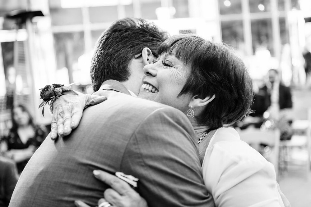 Wedding Day Photos | City Winery | J. Brown Photography | groom and mom hug at ceremony.