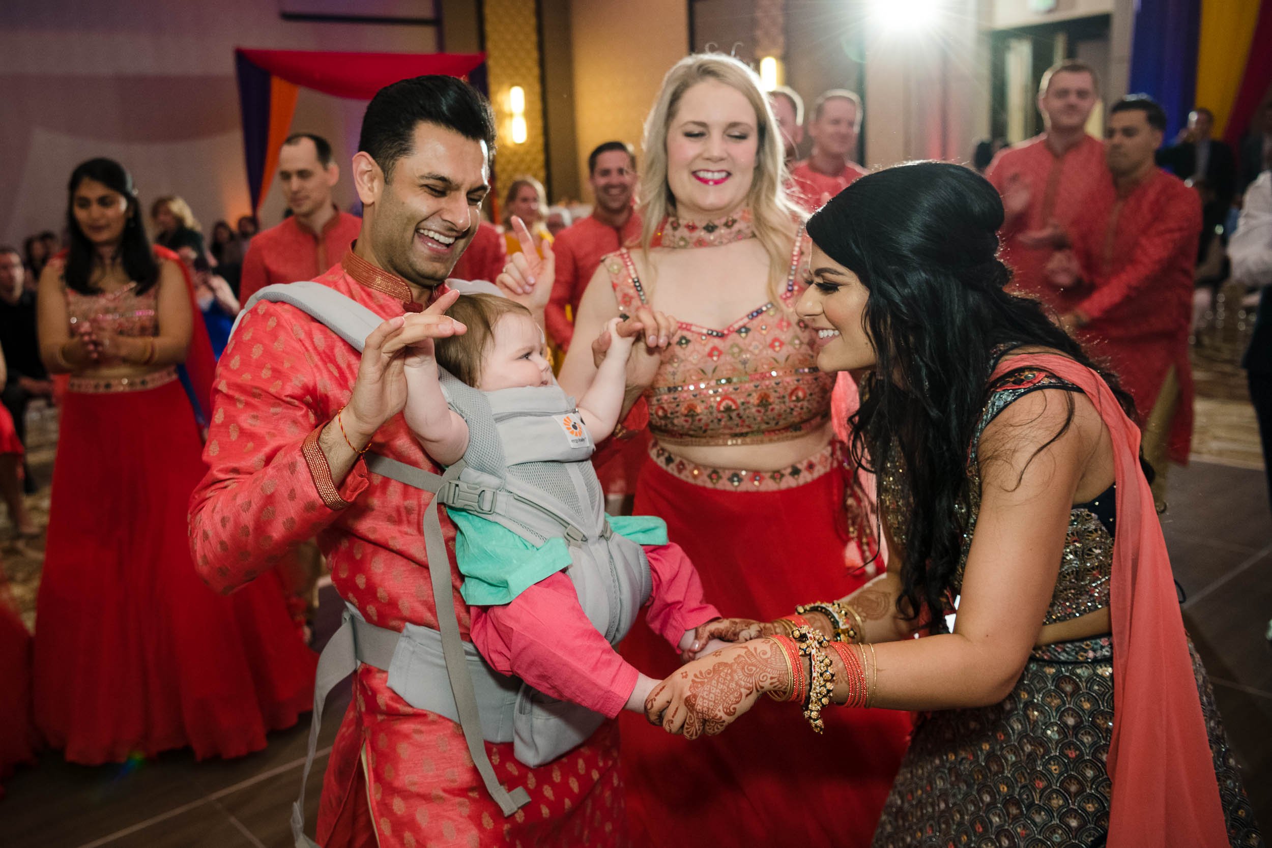 Indian Wedding Photographers | Renaissance Schaumburg | J. Brown Photography | bride dances with family during Sangeet.
