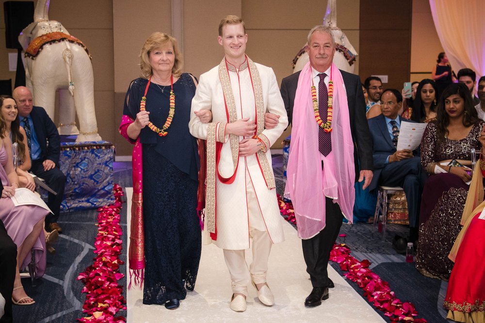 Indian Wedding Photographers | Renaissance Schaumburg | J. Brown Photography | groom walks down the aisle during ceremony.