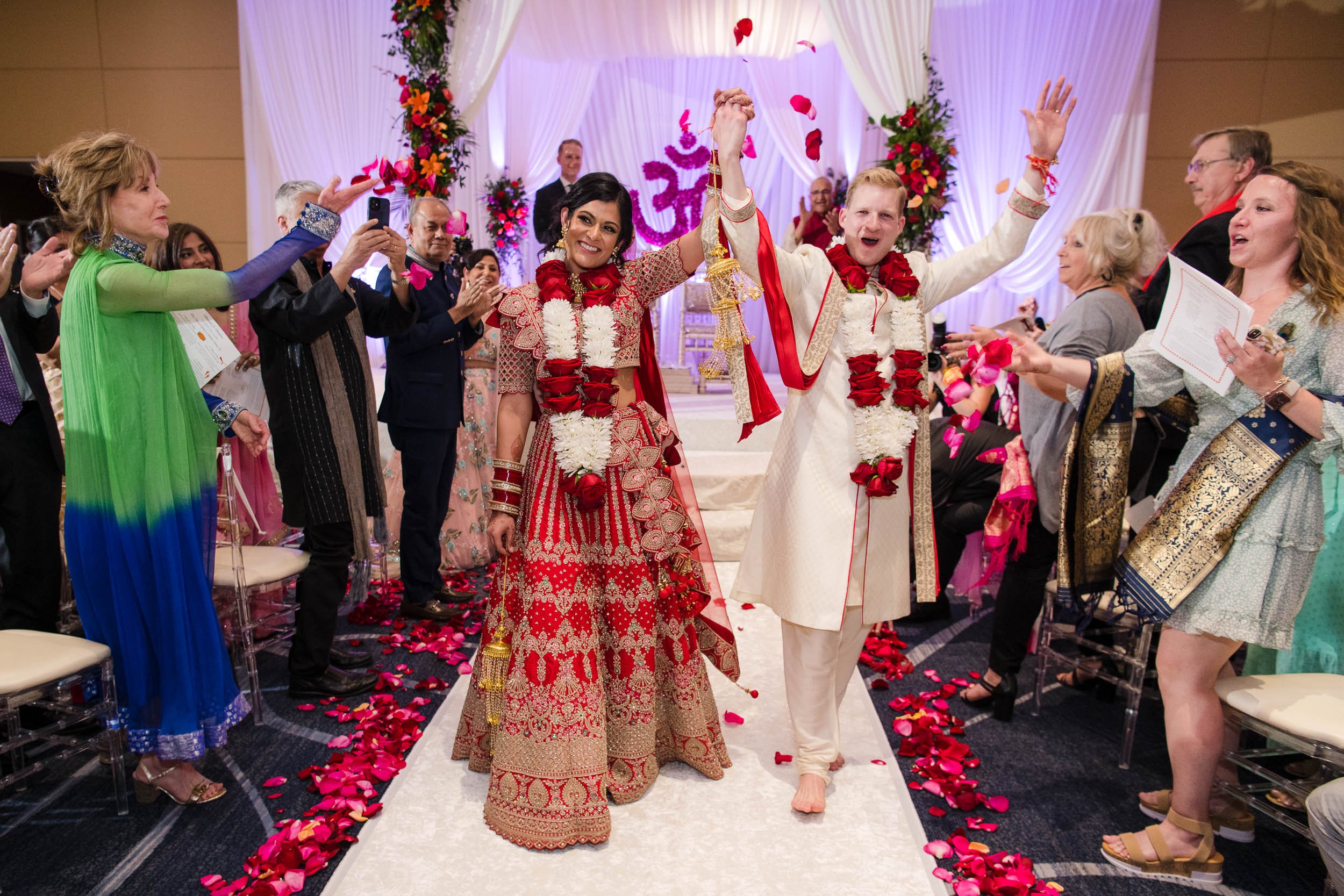 Indian Wedding Photographers | Renaissance Schaumburg | J. Brown Photography | bride and groom walk down the aisle during Indian wedding ceremony.