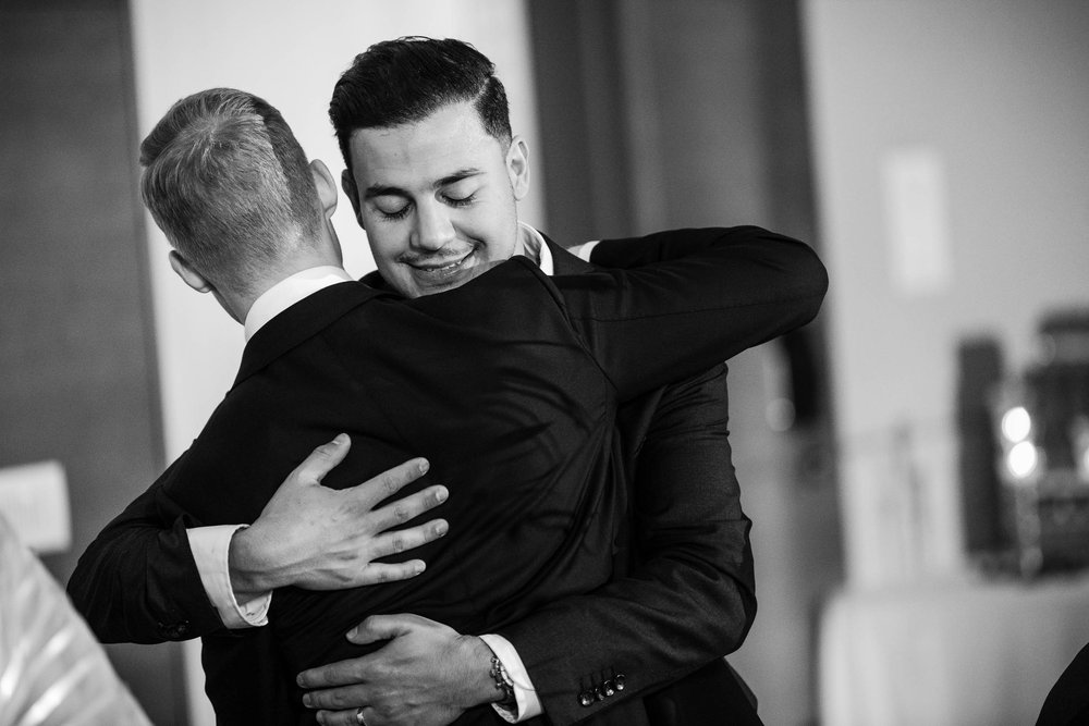 Chicago Wedding Photographer | Renaissance Schaumburg | J. Brown Photography | groom and best man hug.