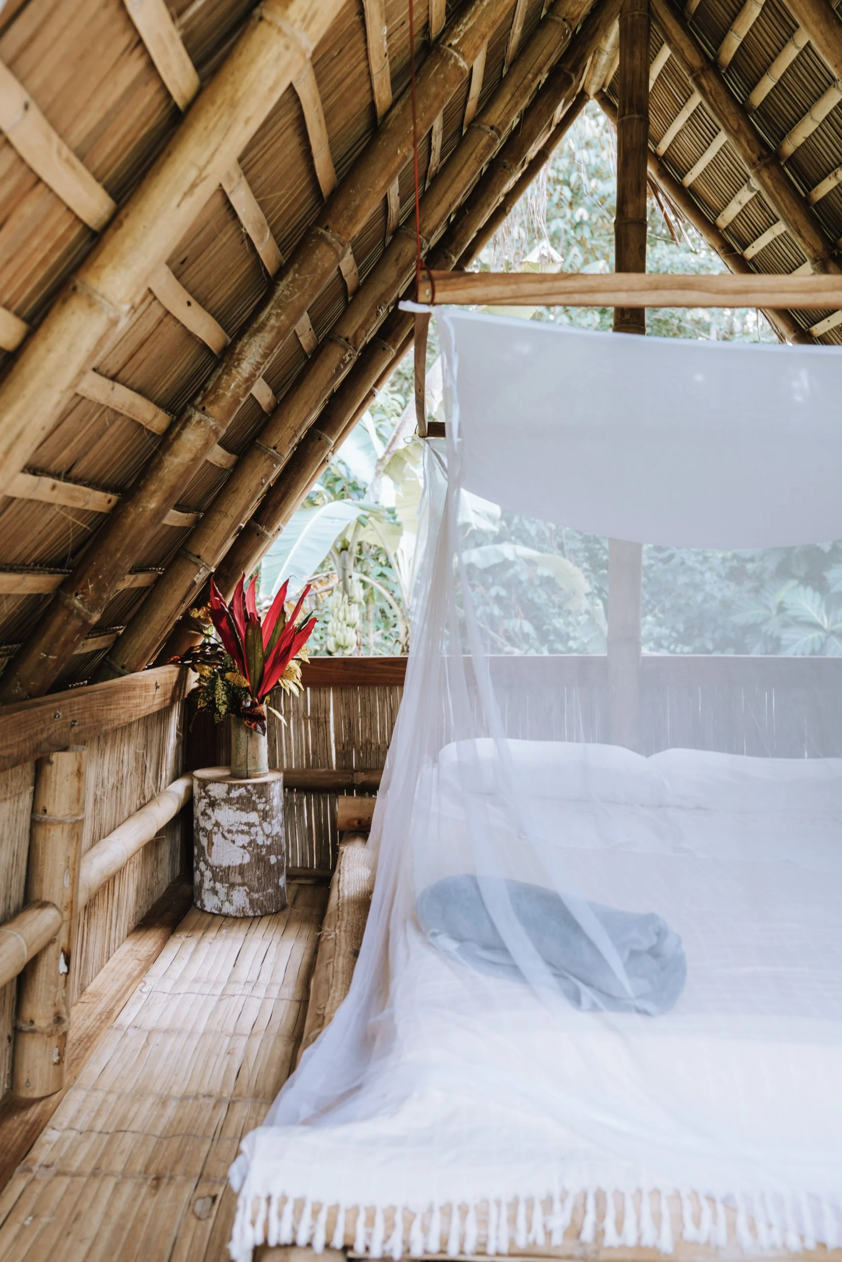 Simple bamboo cabin interior with mosquito net designed for quiet sleep in the Costa Rican rainforest