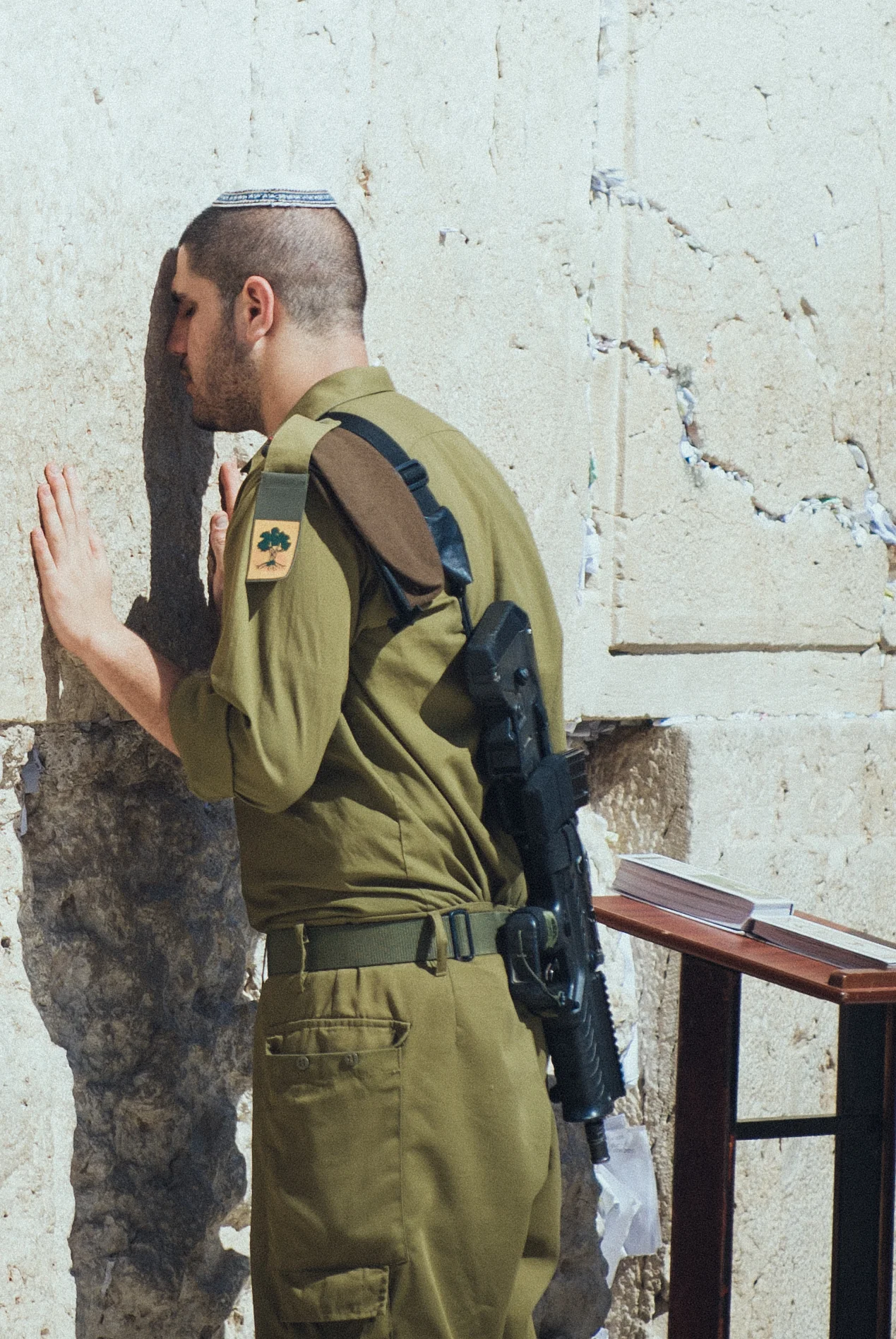 Young Israeli soldier meditating the Torah & praying at the Wall in Jerusalem