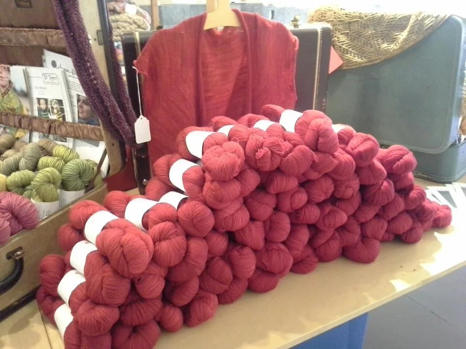 Wash My Lace in 1 Red Shoe shown in front of the Adrift cardigan by Carol Feller.