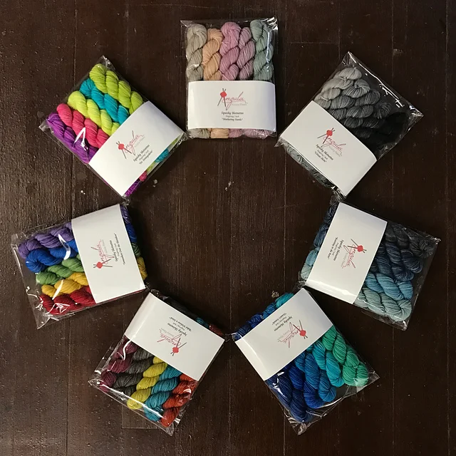 Clockwise from top: Wuthering Hanks, Citizen Skein, Knitting in the Rain, Ocean's Anzula, Rebel Without a Stitch, Somewhere Over the Skeinbow, and Dr Strangeskein