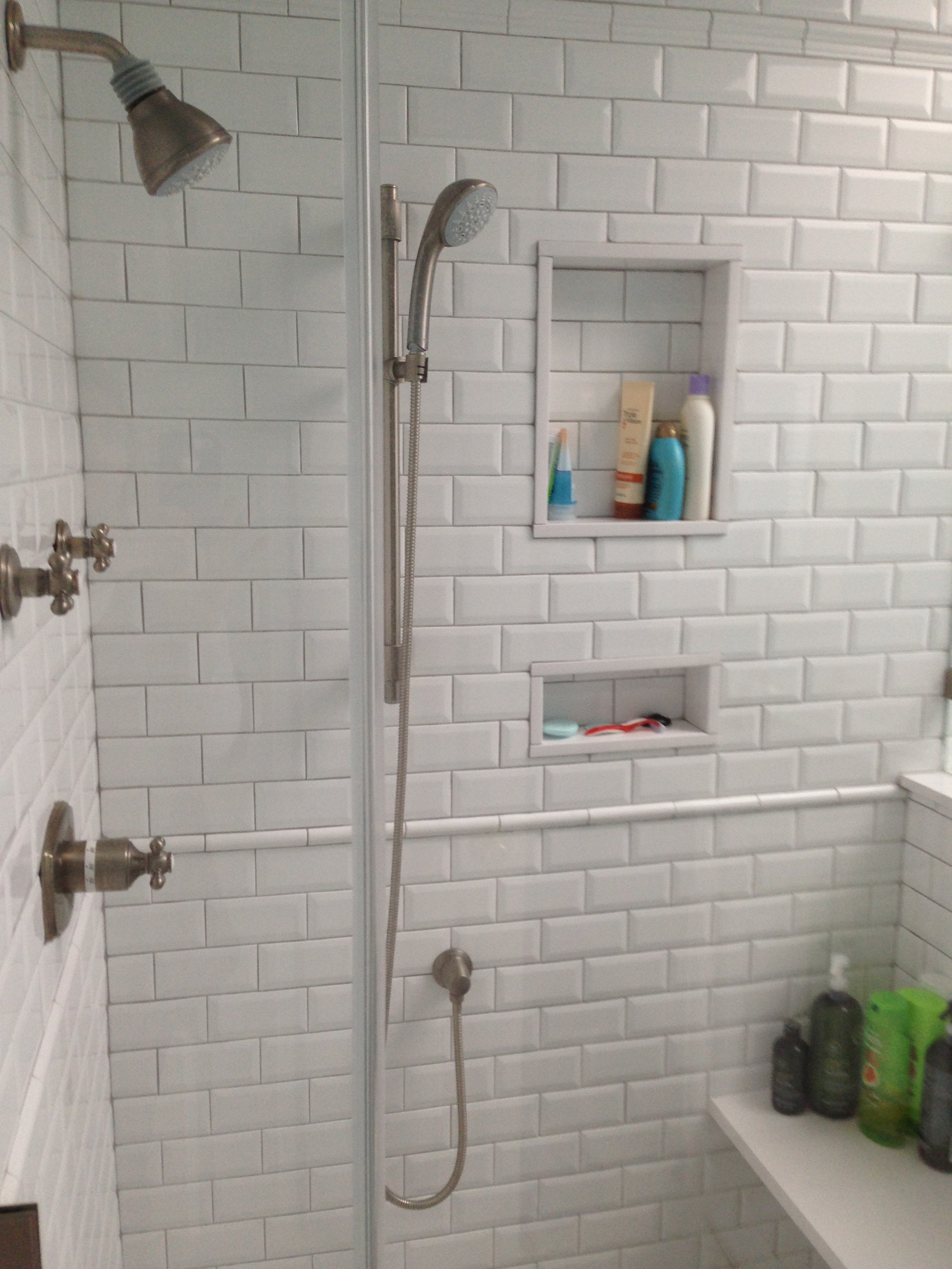 Classic white with gray grout and brushed nickel fittings.