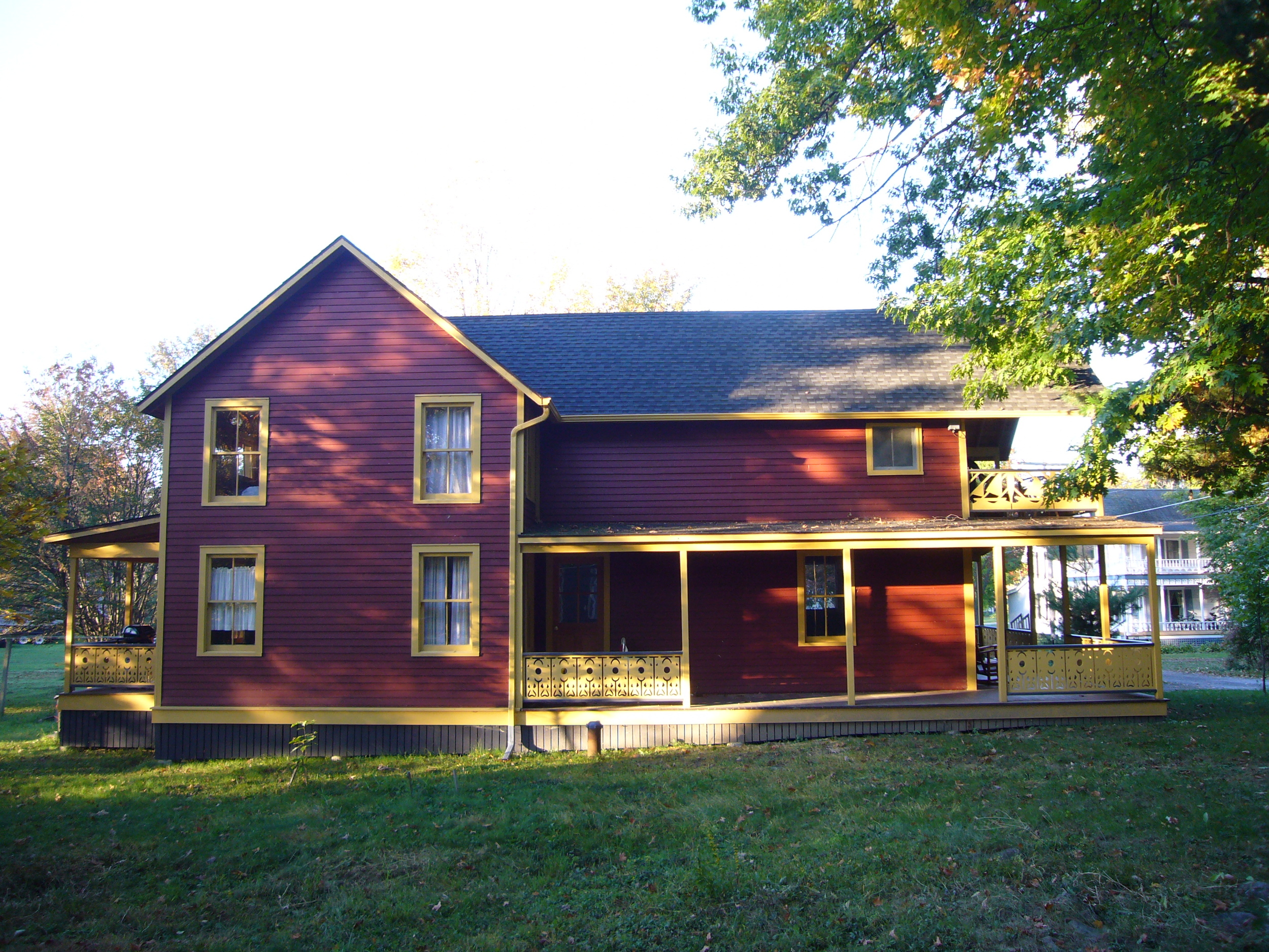 East Elevation - The addition, on the south side of the original structure, replaced a one-story shed roof with a two-story gable to match the existing.
