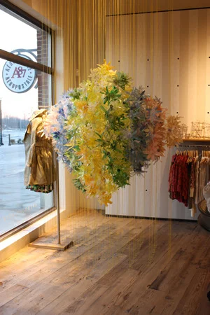 To suspend the flowers, I strung mason line from floor to ceiling in a series of rows (it took a lot of mathematical calculation and fancy ladder maneuvers to keep them straight). I then attached the flowers to the mason line with wire and pipe cleaners. 