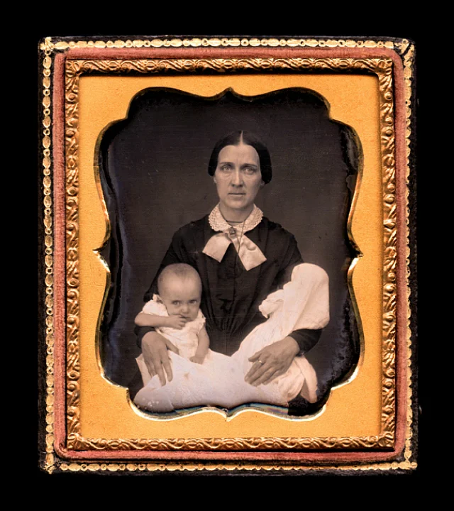“The Twins” (1852), sixth-plate daguerreotype, 3.75″ x 3.25,” where a woman holds two infants, one living and the other dead (courtesy Thanatos Archive )