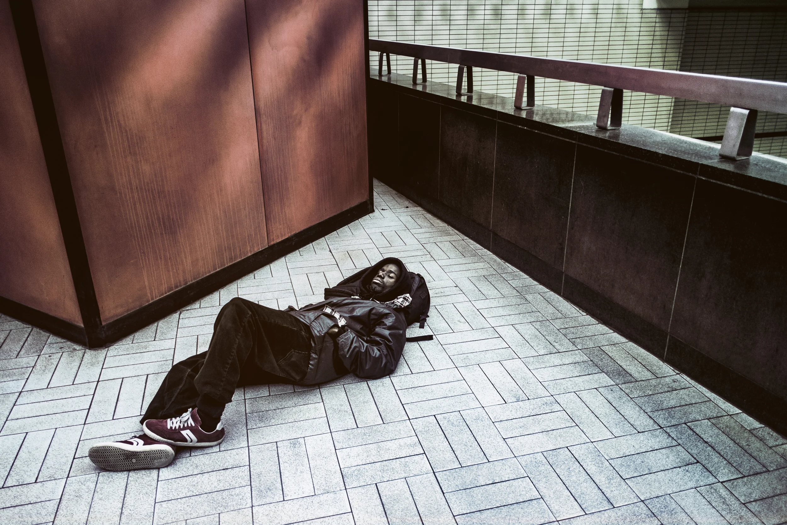 A man sleeping inside Sherbrooke Metro, Montréal, Québec. 