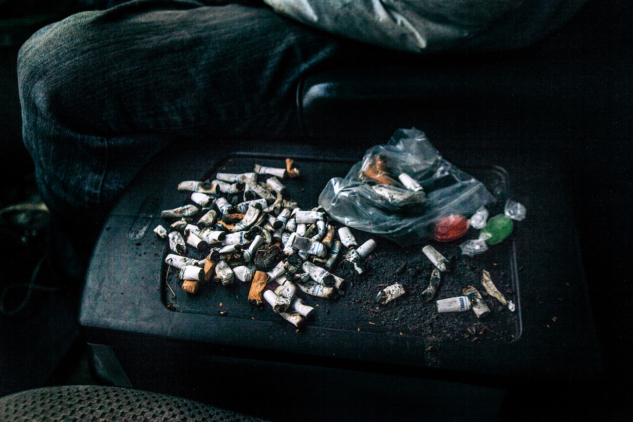  Cigarette butts on the centre console of Lisa. Gregory finds these butts in his travels, and uses the ends the roll into a cigarette.&nbsp; 