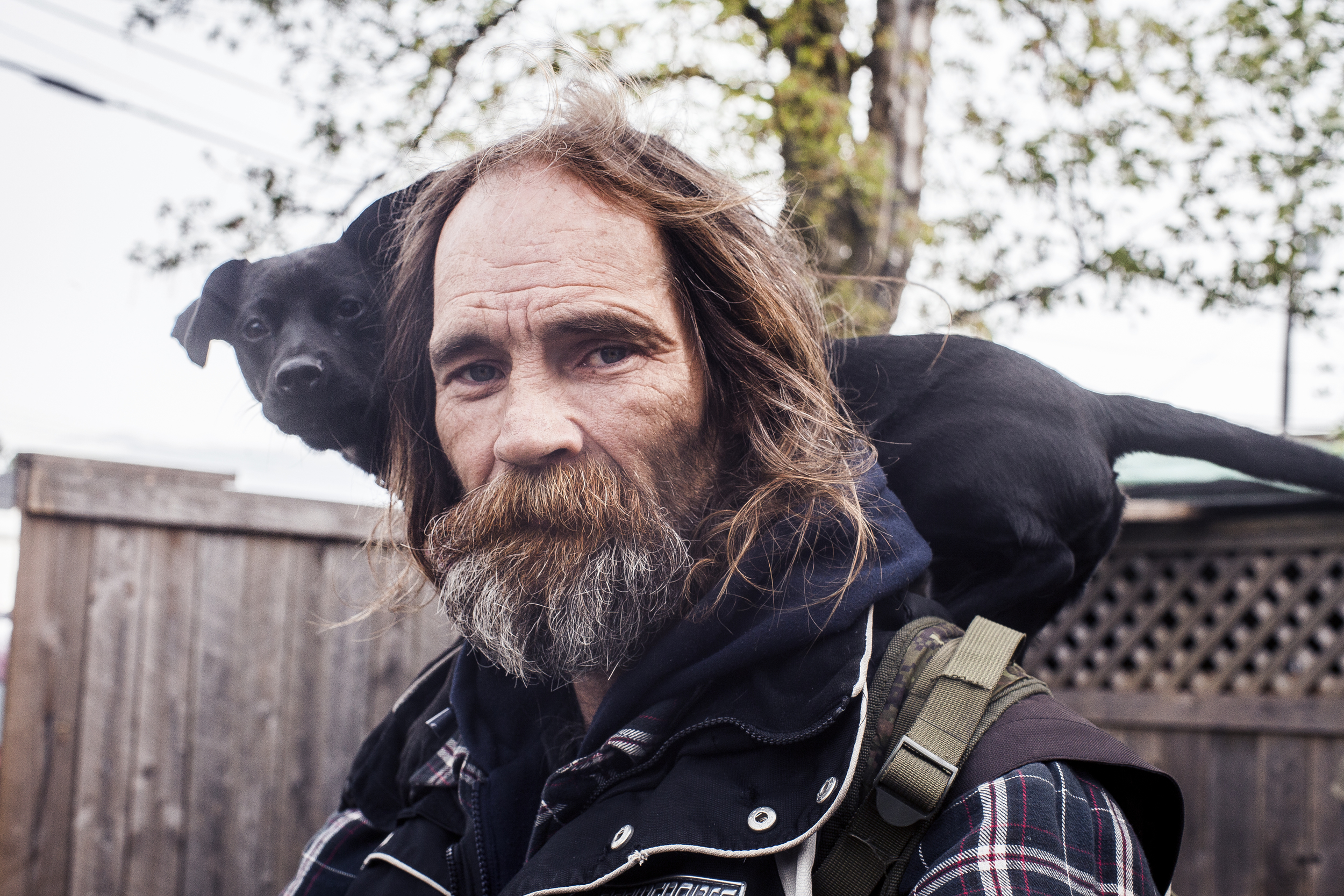  A portrait of Rick and his puppy on a bicycle in Marcia's backyard.&nbsp; 