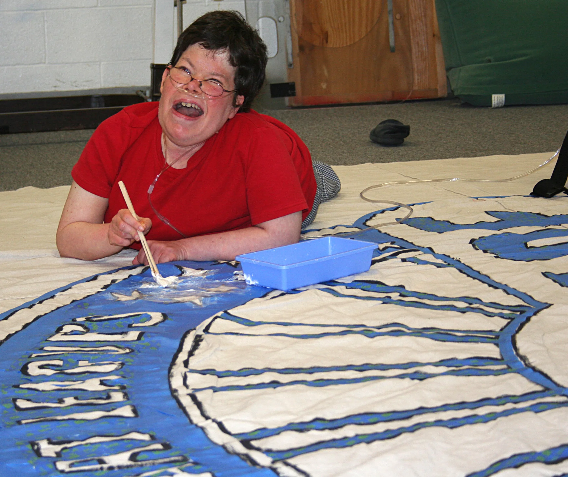 Jill is enjoying some time out of her wheelchair as she works on the Ohio Made logo.