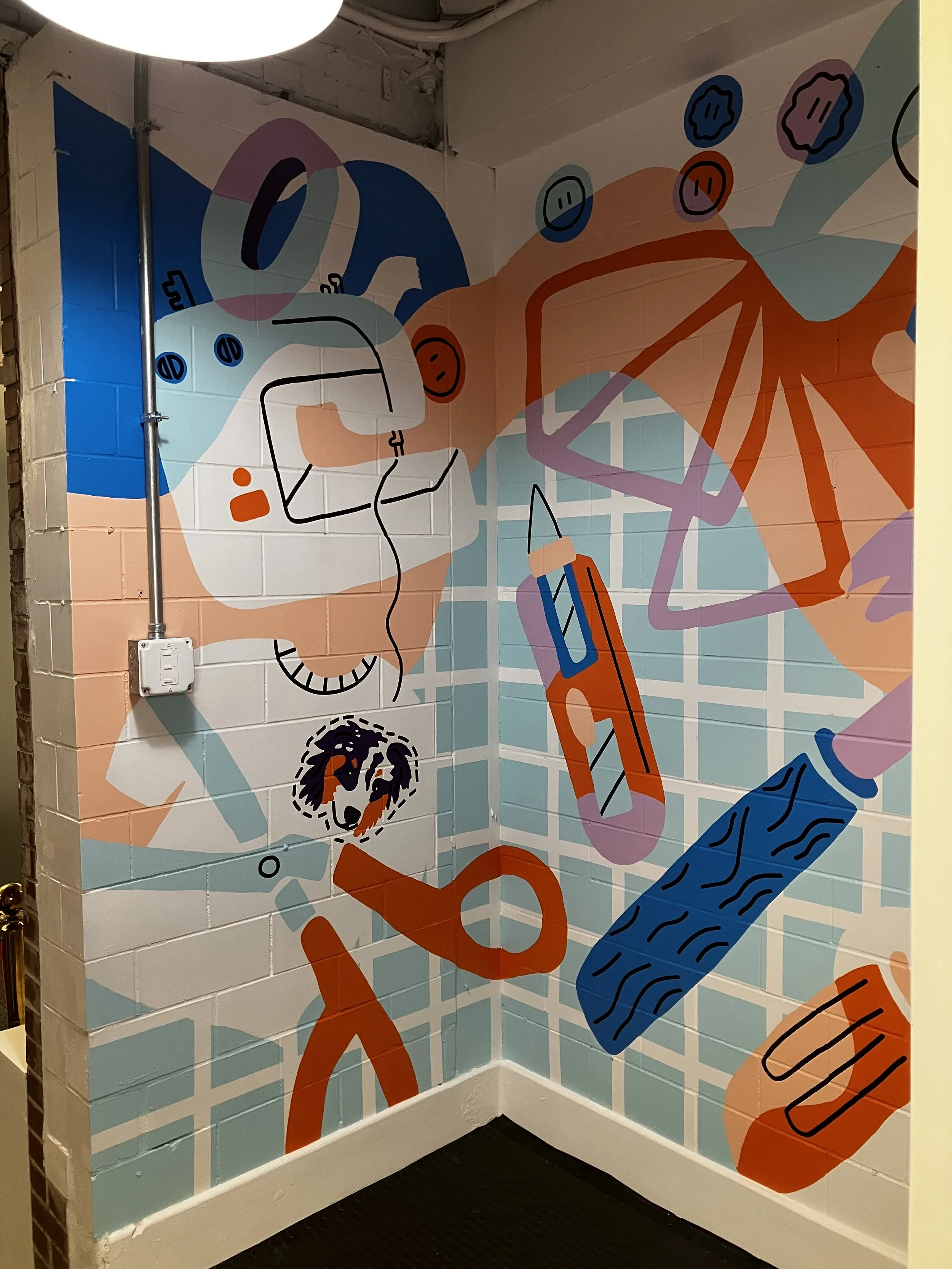 Hand painted  large scale interior mural of art supplies and tools for Somerville, MA office space. 