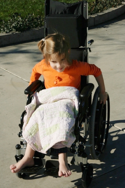 Tiny girl in a tiny wheelchair. January, 2009