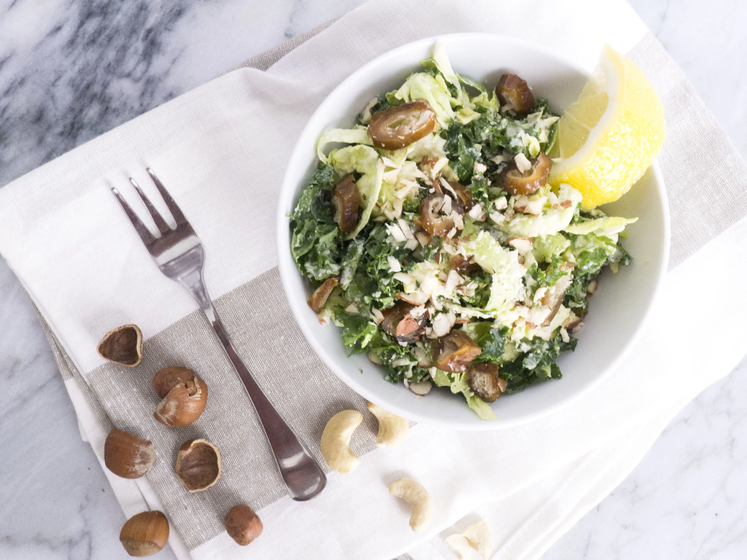 kale and shaved brussels sprout salad with cashew mayo, hazelnuts and dates 