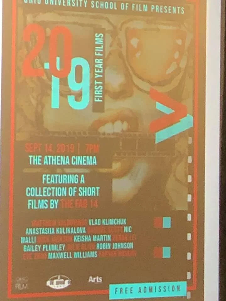 Poster of 1st-Year MFA Films Screening projected on the screen in the Athena Cinema.