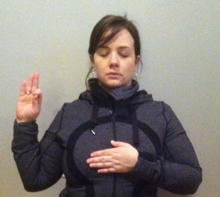 Left hand placed at the heart center; right thumb touching the forefinger and the remaining fingers pointed towards heaven.