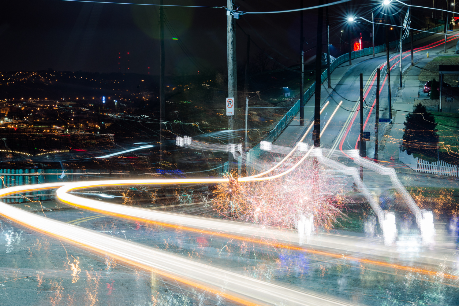 It was while taking images of the road that the fireworks started. I swiveled the camera left on the tripod to capture the fireworks, but was too excited to remember that the shutter wasn't closed from the last shot! This image was too neat to delete.