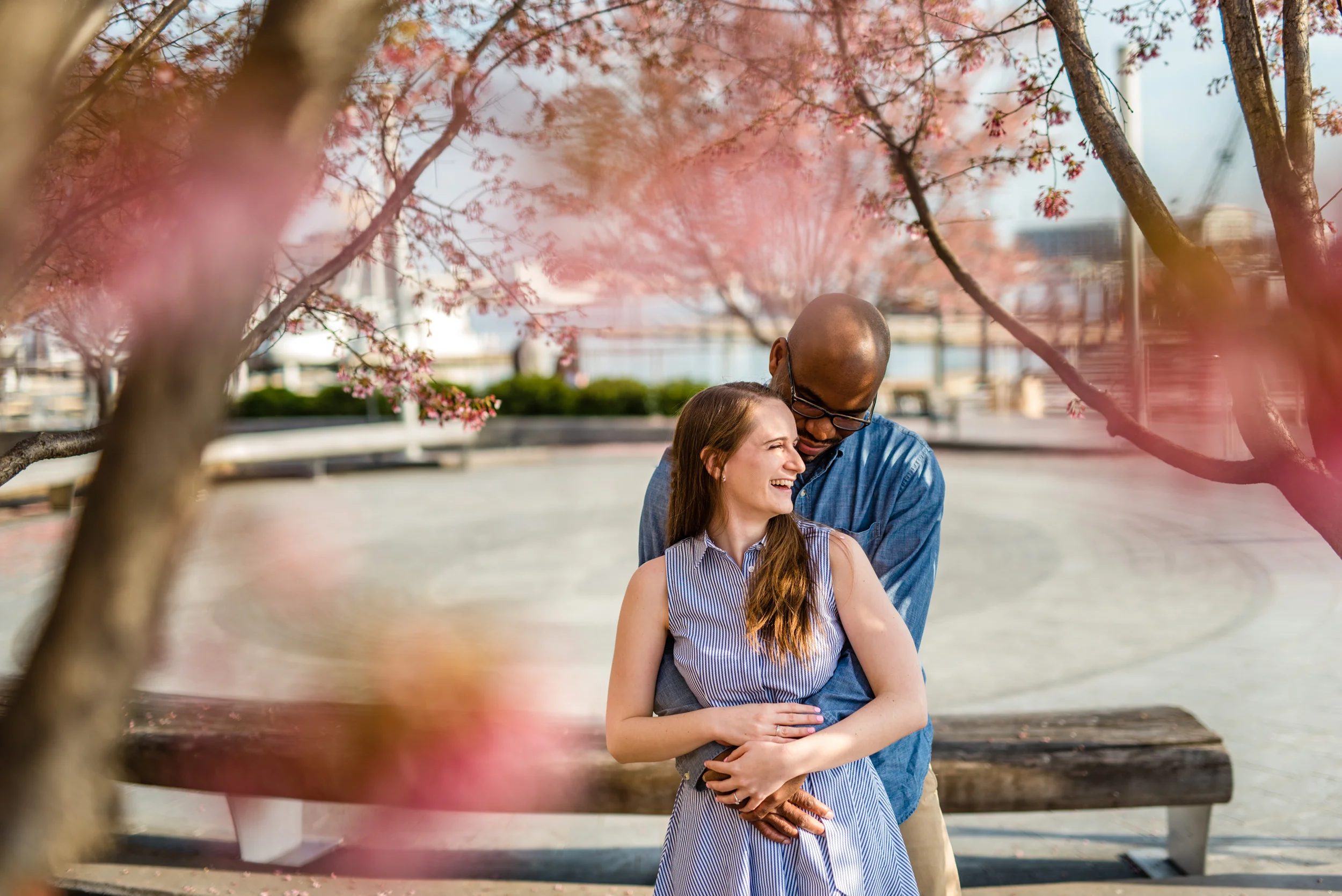  A couple embracing in cherry blossom trees 