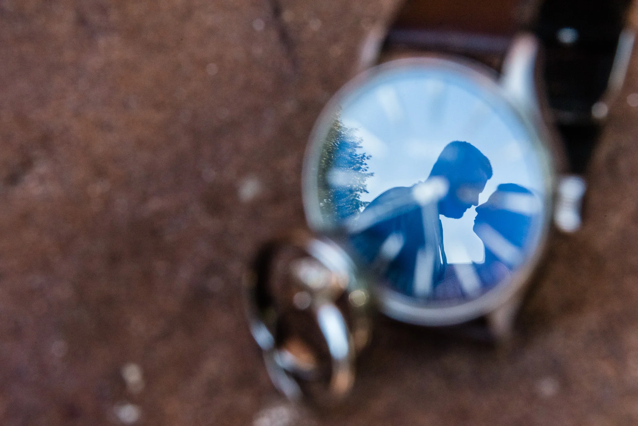  The reflection of the wedding couple in a timepiece. 
