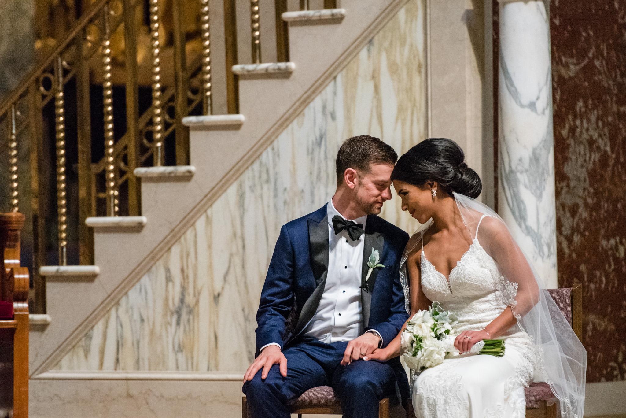 Bride and groom share a quiet moment together during their catholic ceremony