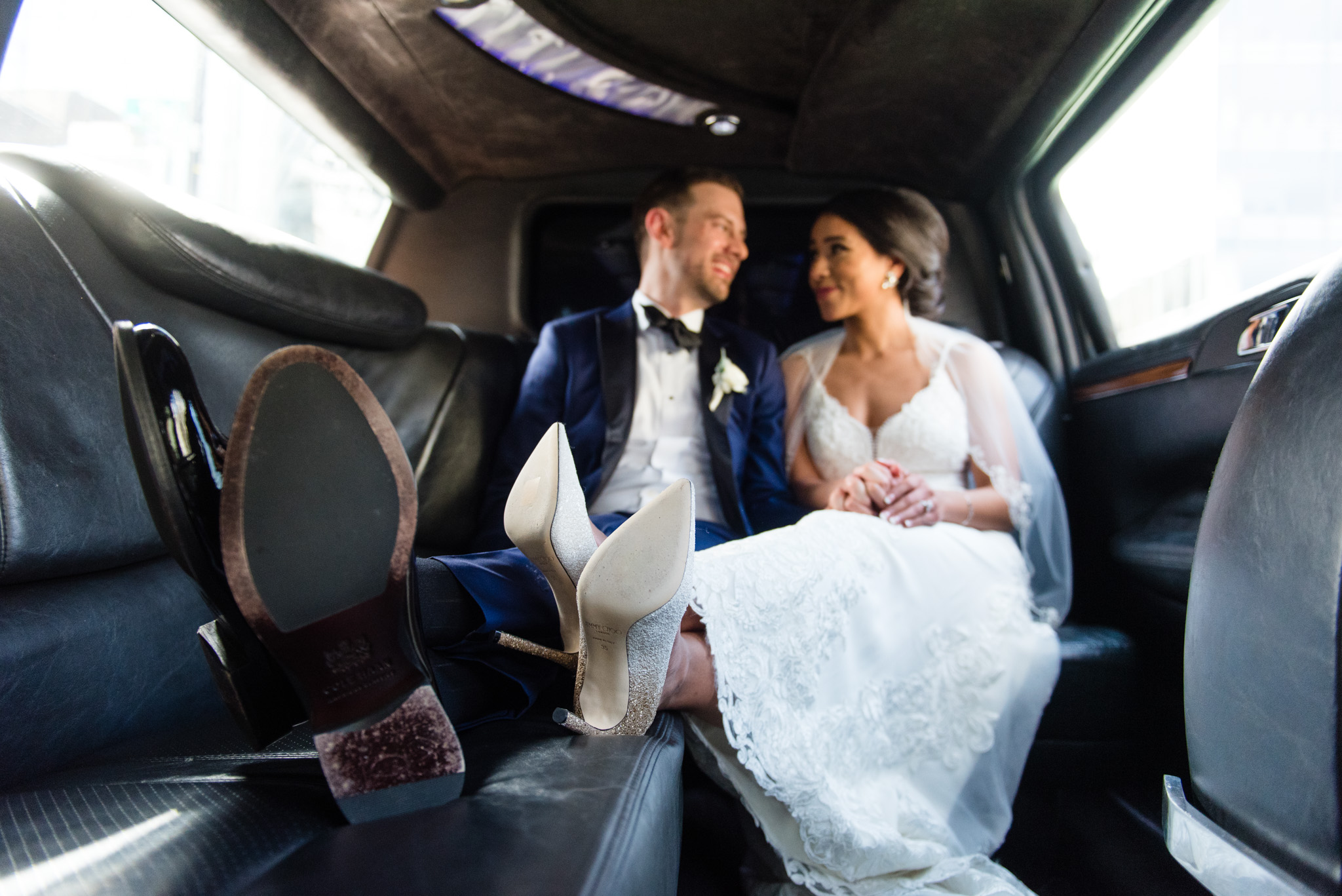 Bride and groom riding in a limo