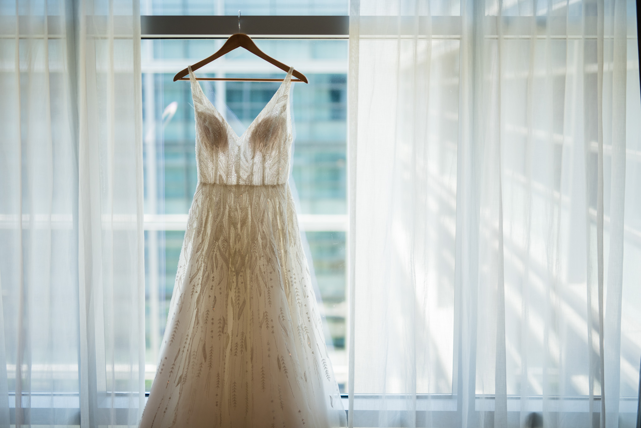 Wedding dress hanging up in a window