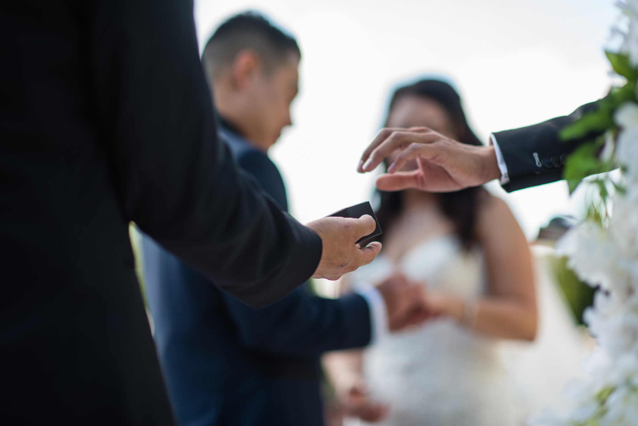 Wedding ring being handed to the officiant 