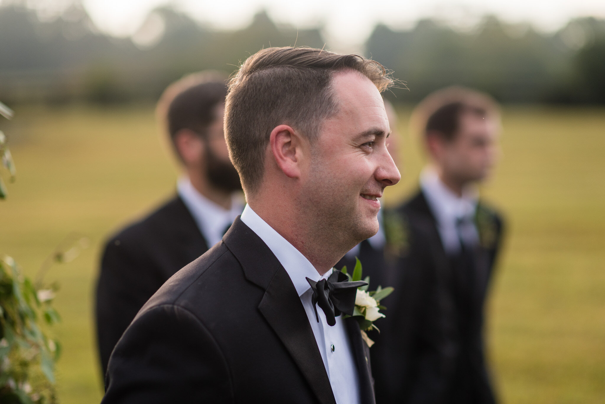 Groom watches his bride walk down the aisle