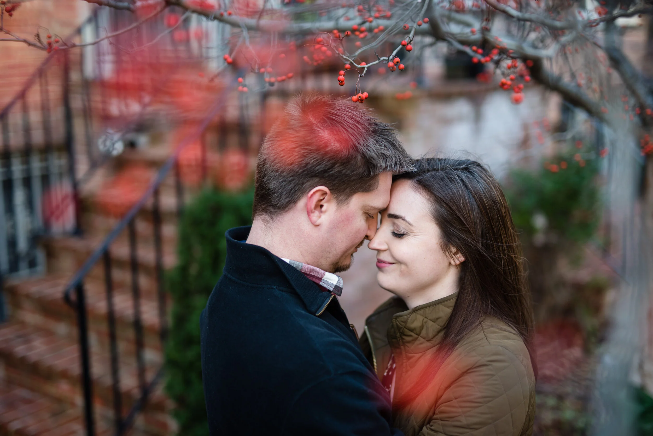 A couple embraces, touching foreheads